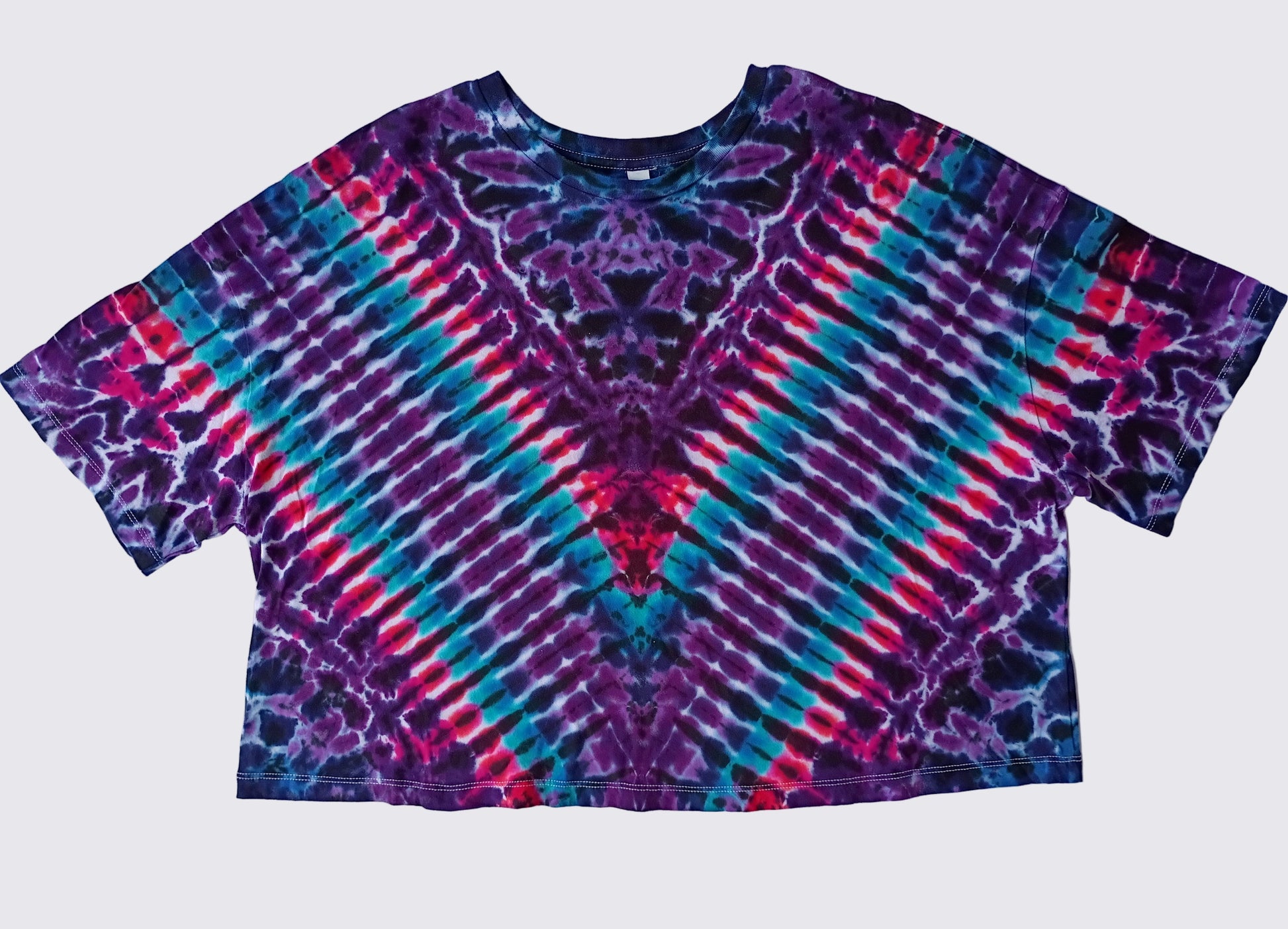 Tie-dye shirt with purple, blue, and red pattern on a white background